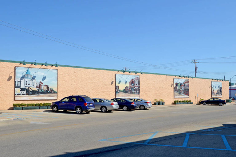Four murals displaying historic scenes of downtown Canton, IL. Murals are hung on the south wall of the JCPenny building.