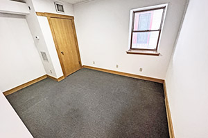 Uptown Plaza, Suite 111, private office number three, offers a window that receives natural light. Is between two neighboring offices.
