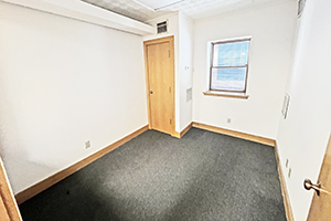 Uptown Plaza, Suite 111, private office number four, offers a window that receives natural light and has an additional window that oversees the main office area. Is next to one neighboring office.