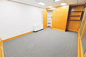 This spacious office provides multiple windows and storage.