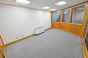 This spacious office provides multiple windows and unique characteristics.
