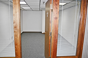 Graham Plaza, Suite 015, door opening to a cozy office space.