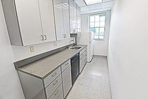 Showers, Suite 121, offers a full kitchen with a refrigerator, dishwasher, sink, and plenty of sleek cabinets.