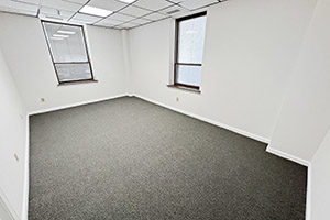 One of two private offices. Provides two windows and leads directly into the reception area..