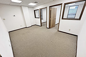 Graham Plaza, suite 450, offers a spacious reception area. The reception area leads to two private offices. Each office offers a window on the wall between the reception area.