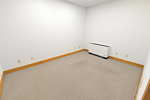 Fountain Square, Suite 212, provides a spacious private office with white walls and tan colored carpet..