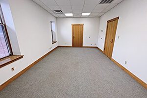 Uptown Plaza, Suite 213, offers a spacious office with two windows.